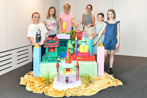 Die Nachwuchs-Architektinnen des Kindeshauses präsentieren zusammen mit Projektleiterin Barbara Brix-Uebbing (links) und Kinderhausleiterin Christina Wacker stolz ihr Traumschloss im Rathaus-Foyer.